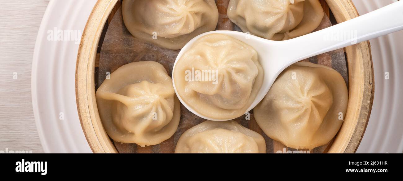 Eating steamed pork soup dumplings named Xiao long bao xiaolongbao in