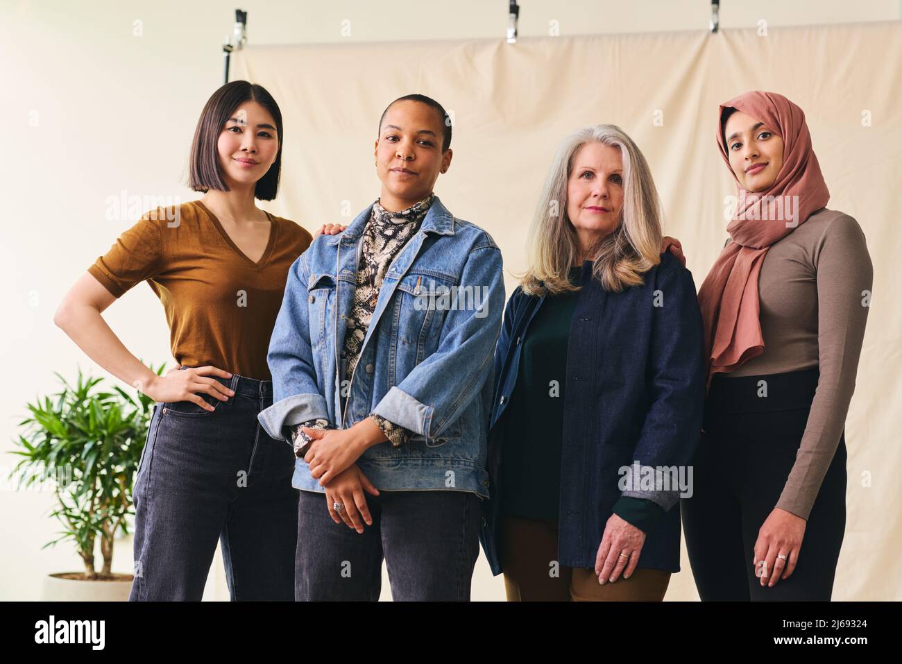 Mid adult multiracial LGBTQ woman in support of International Women's Day with multi ethnic female friends Stock Photo