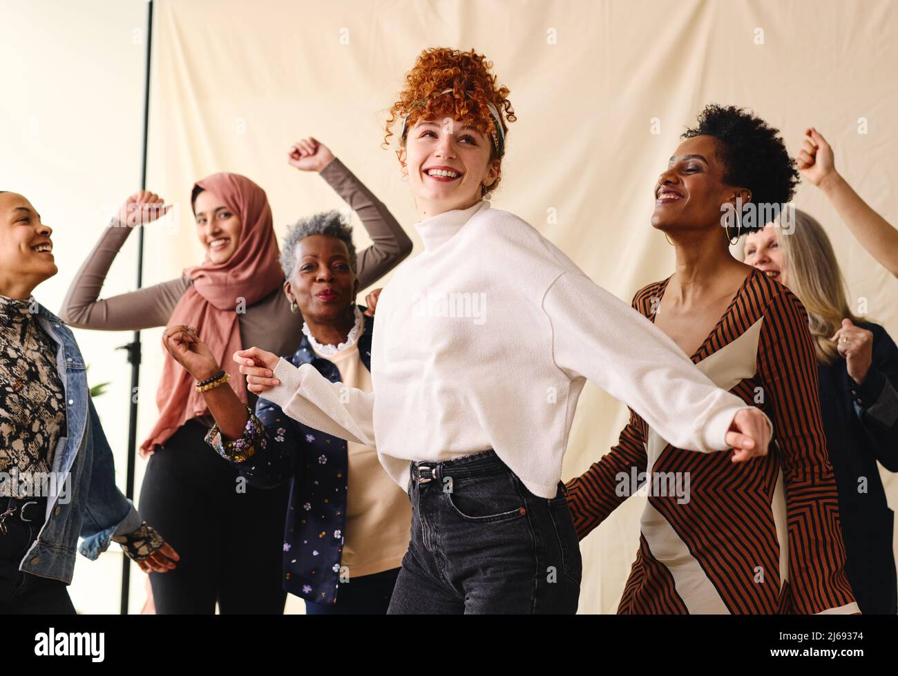 International Women's Day candid portrait of multi ethnic mixed age range women dancing Stock Photo