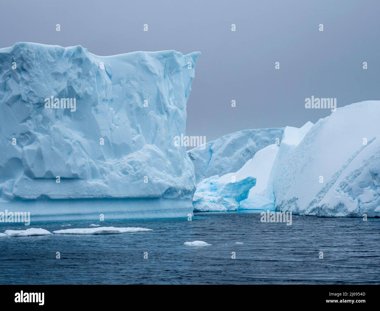 A huge iceberg grounded on a reef near the Iceberg Graveyard, Petermann Island, Antarctica, Polar Regions Stock Photo