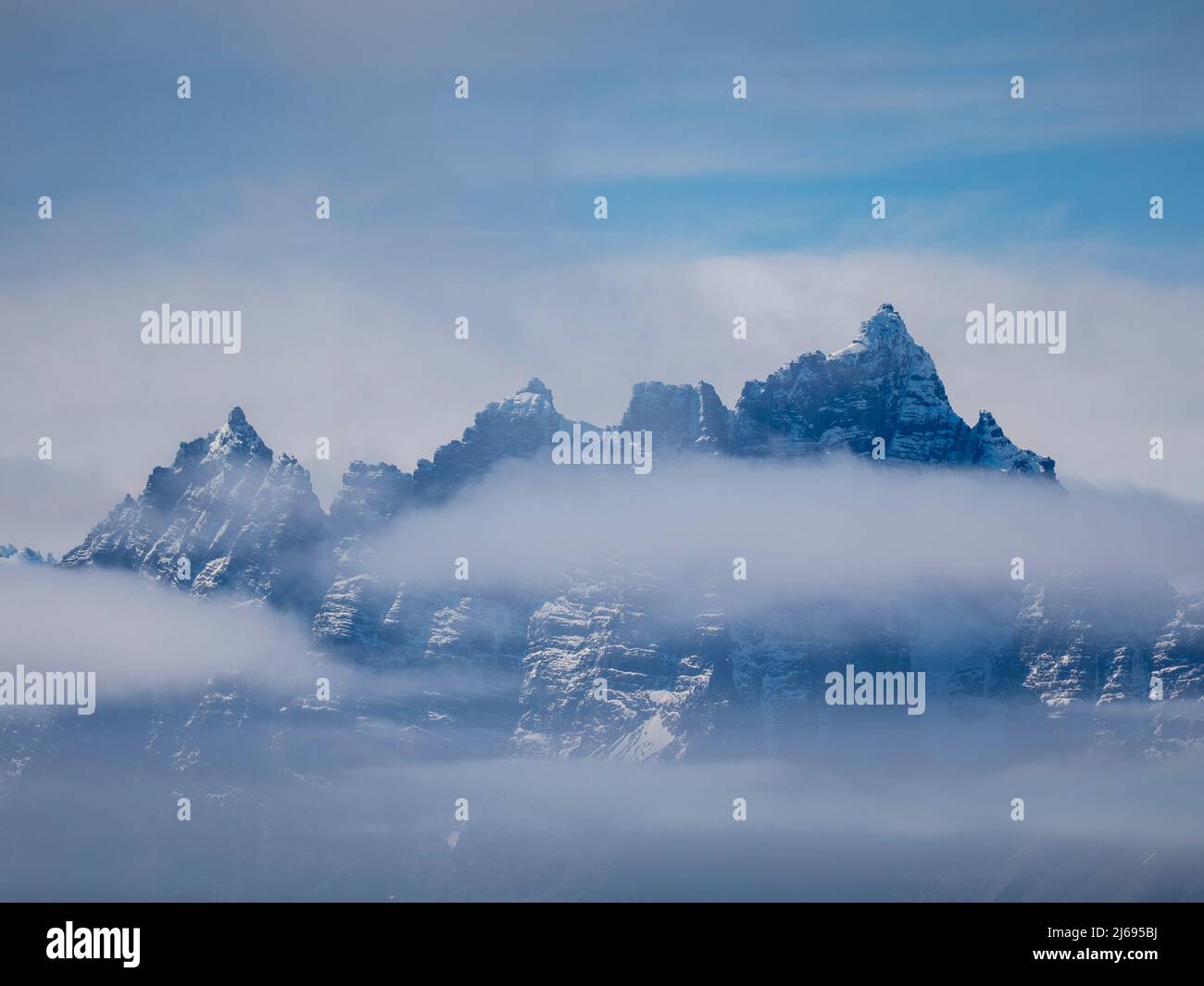 Fog obscures the rugged mountains and glaciers of the south side of the South Georgia coastline, South Georgia, South Atlantic, Polar Regions Stock Photo