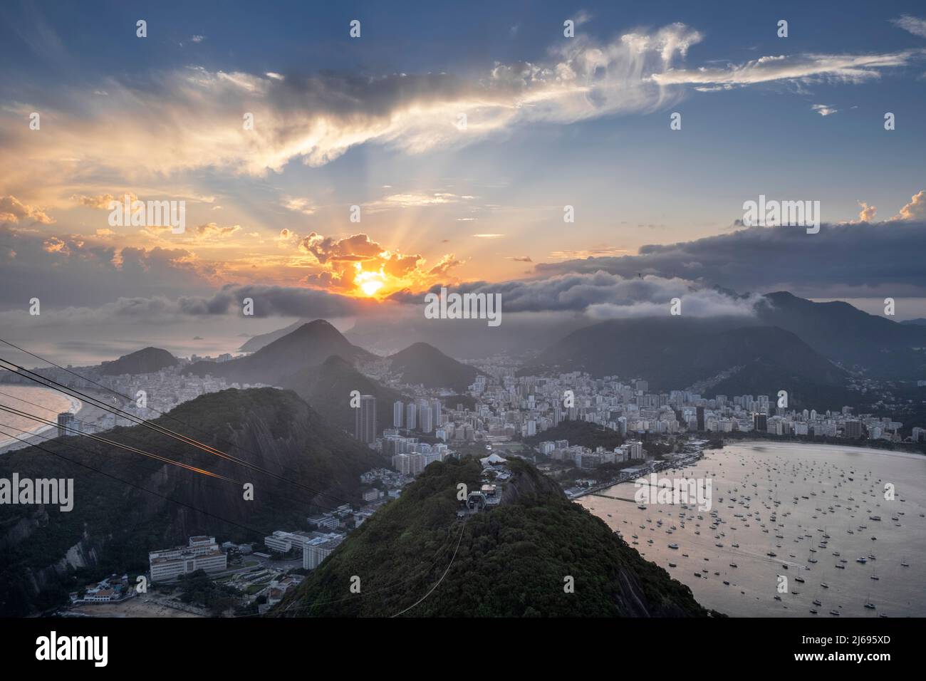 Sunset over the city skyline and Rio's mountains and beaches from the summit of Sugar Loaf mountain, Rio de Janeiro, Brazil Stock Photo