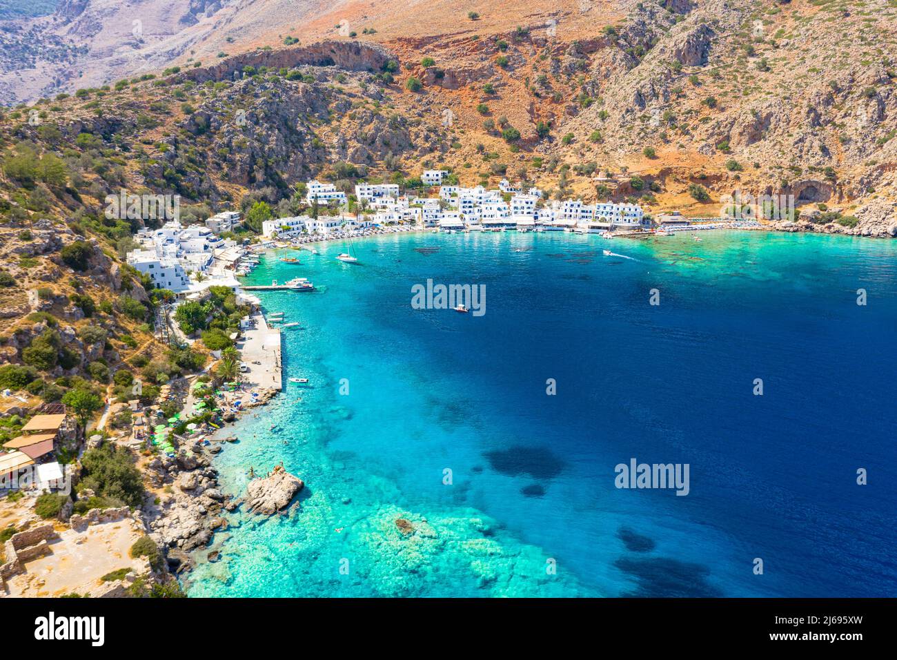 Aerial view of traditional whitewashed buildings of Loutro village and transparent sea, Crete island, Greek Islands, Greece Stock Photo