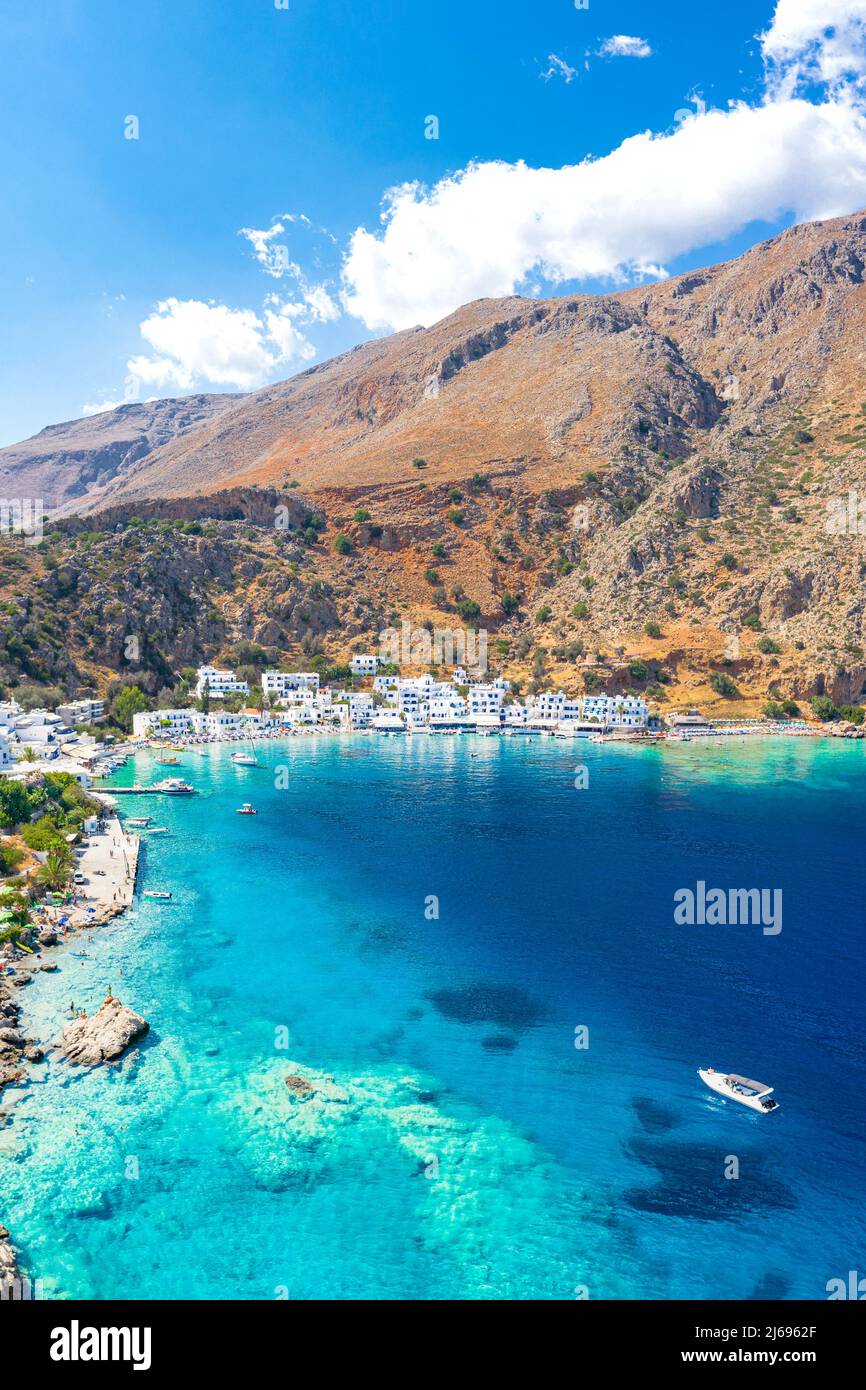 Aerial view of seaside village of Loutro nestled in the idyllic cove washed by turquoise sea, Crete island, Greek Islands, Greece Stock Photo