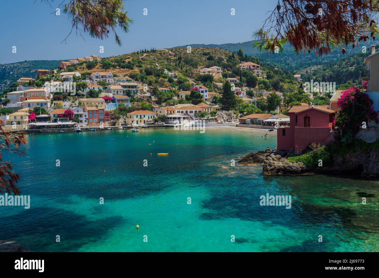 Sunny view of traditional Asos Village with low-rise houses by the sea in Kefalonia village, Kefalonia, Ionian Islands, Greek Islands, Greece, Europe Stock Photo