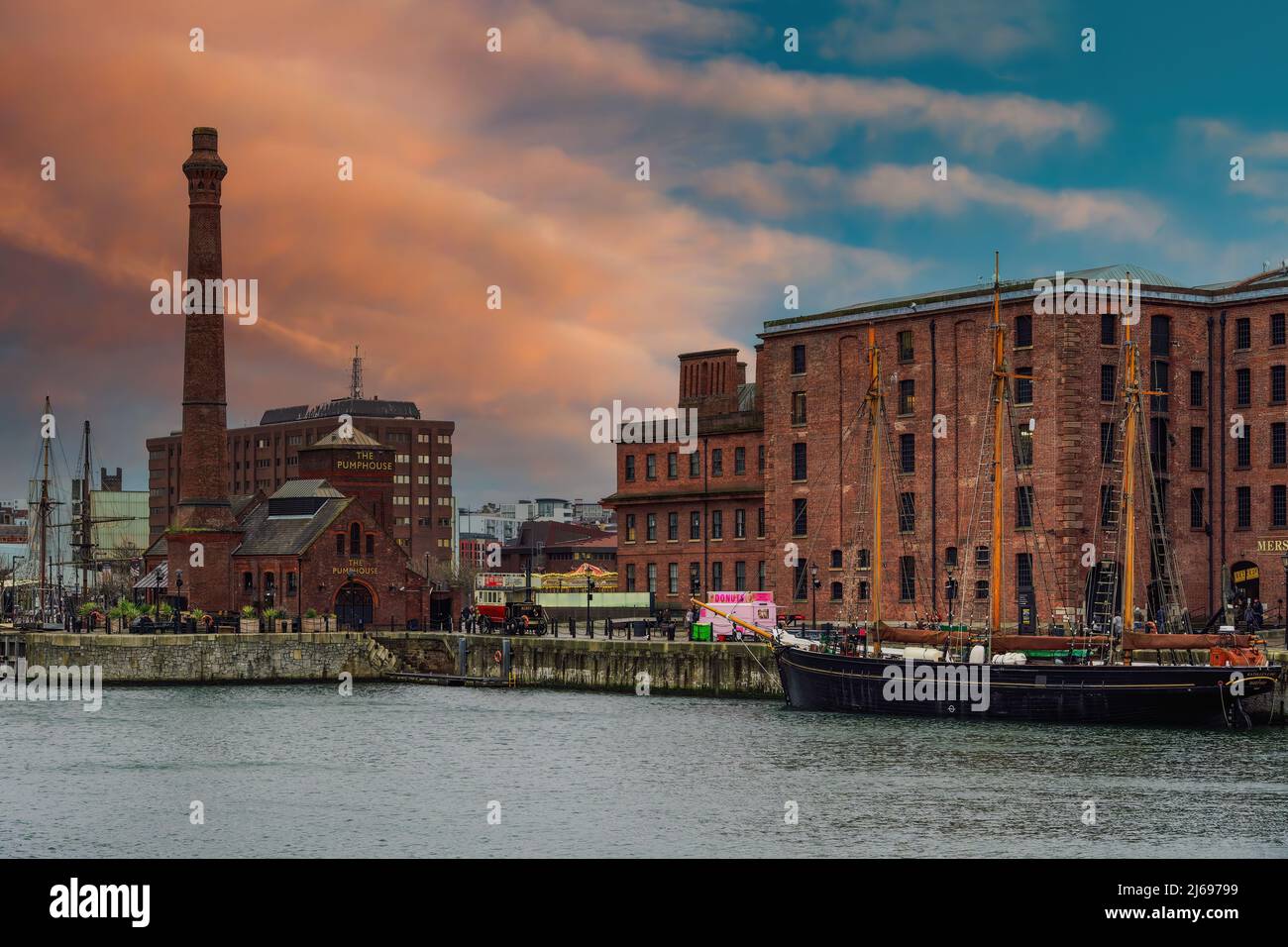 Evening view of Royal Albert Dock brick and stone buildings and warehouses, including The Pumphouse, Liverpool, Merseyside, England, United Kingdom Stock Photo