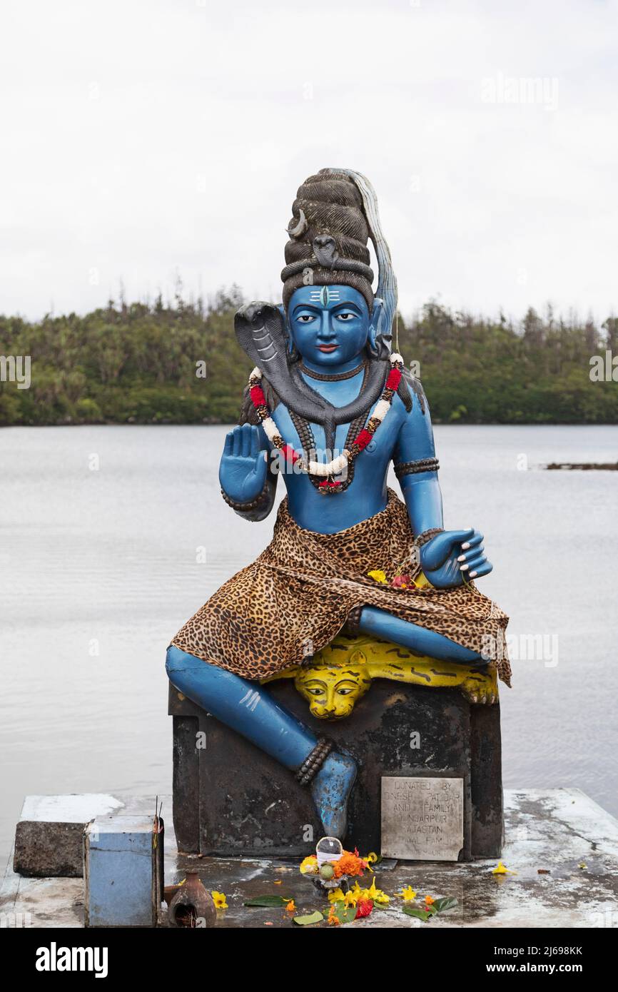 Statue of Vishnu, the Hindu god with cobra and wearing a leopardskin, in human form as Krishna, at Ganga Talao, Mauritius, Indian Ocean, Africa Stock Photo