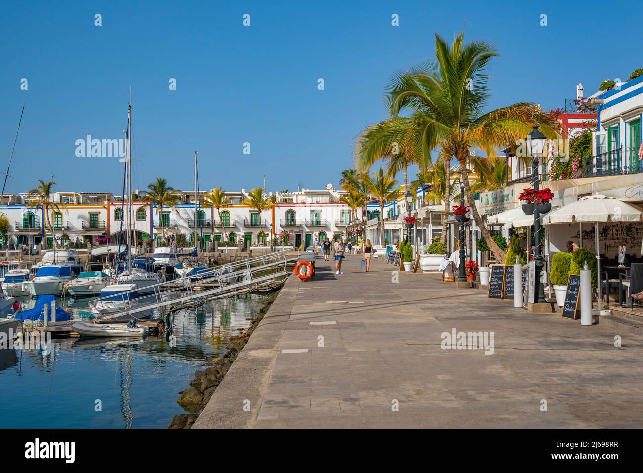 View of boats and colourful buildings along the promenade in the old town, Puerto de Mogan, Gran Canaria, Canary Islands, Spain, Atlantic, Europe Stock Photo