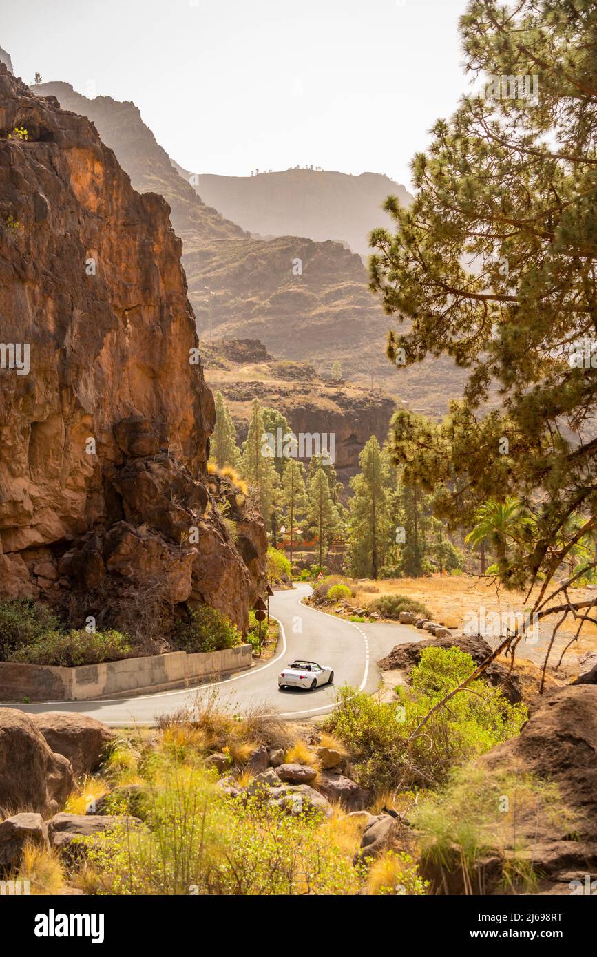 View of car driving through mountainous landscape near Barranco de Mogan, near the village of Mogan, Gran Canaria, Canary Islands, Spain, Atlantic Stock Photo