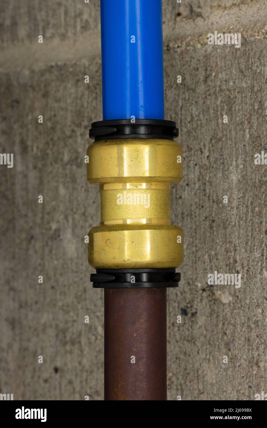 A pex pipe push to connect fitting joining old copper pipe to new blue