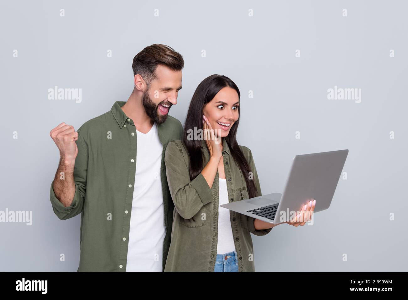 Portrait of attractive successful cheerful couple using laptop having ...