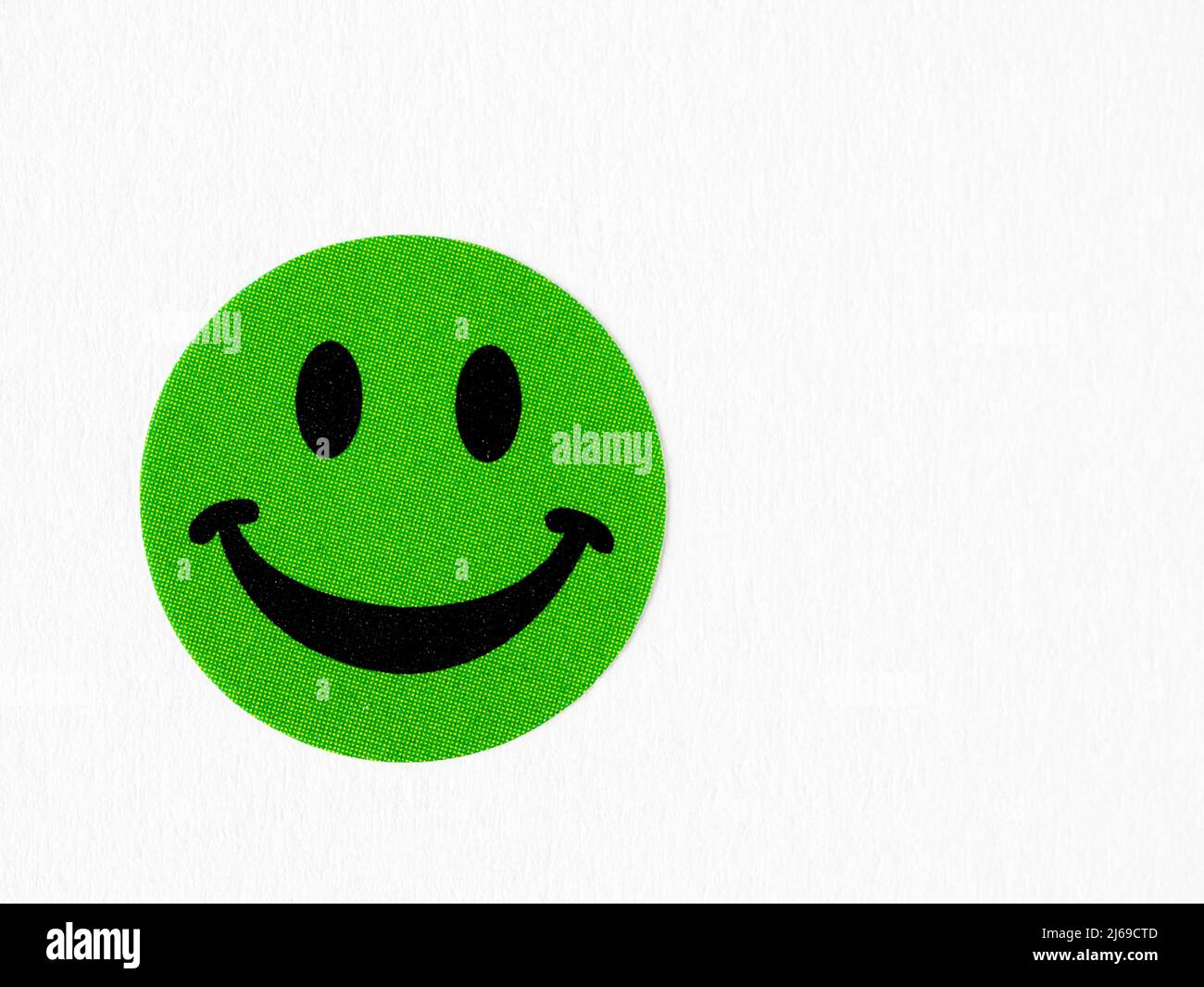 Green children and adult craft smilling happy face sticker on white background Stock Photo