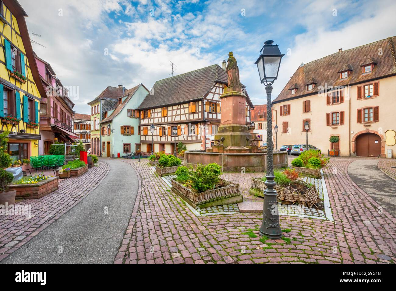 Ribeauville, France. Colorful half-timbered houses on Place de la Sinne square Stock Photo