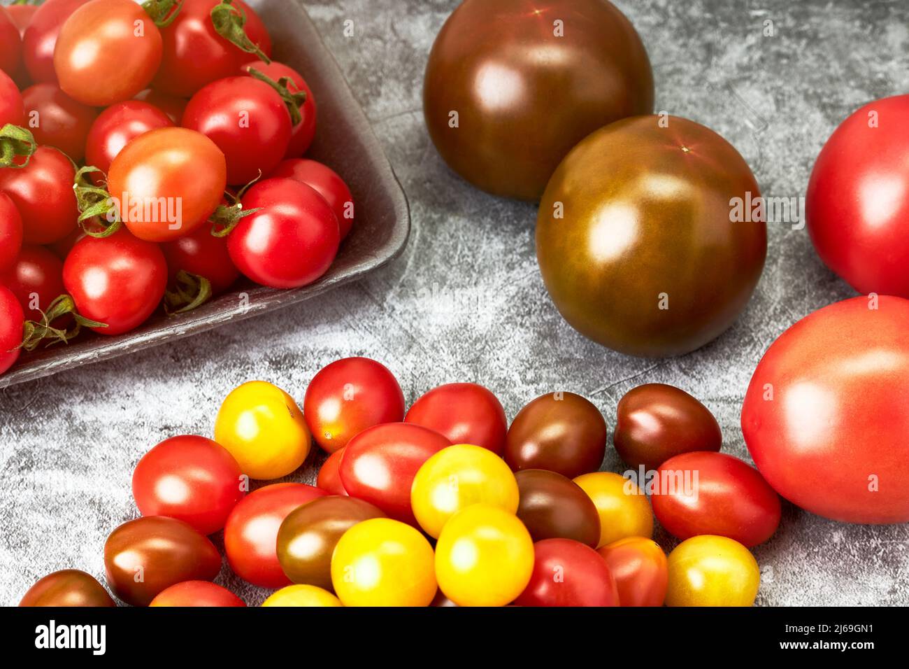 Tray with cherry tomatoes of various colors. Healthy food. Vegetarian and vegan food Stock Photo