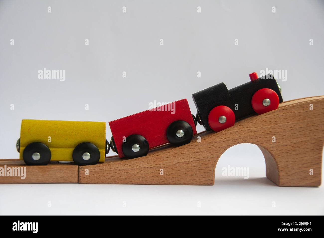 Wooden toy train crossing track bridge. Conceptual Stock Photo Alamy