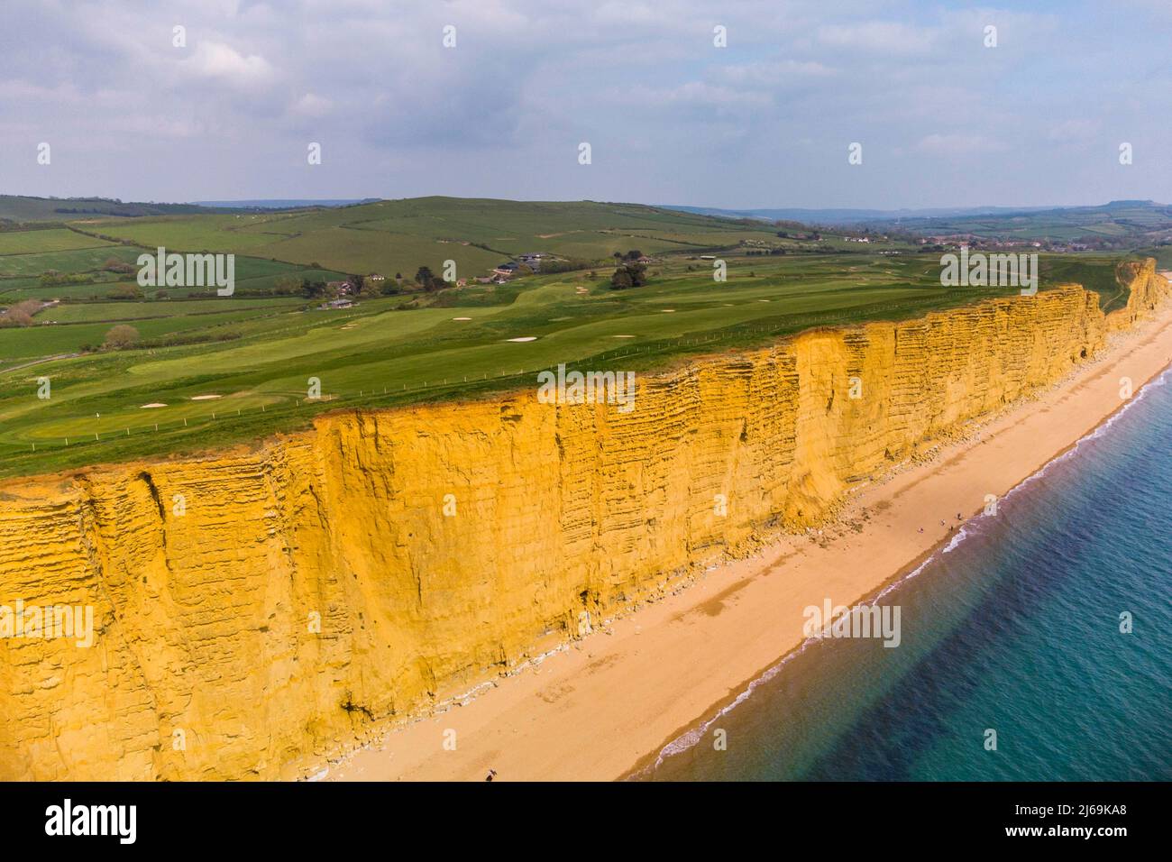 West Bay, Dorset, UK.  29th April 2022.  UK Weather.  General view from the air of the beach and sandstone cliffs at the seaside resort of West Bay in Dorset which is bathed is hot sunshine ahead of the bank holiday weekend.  Picture Credit: Graham Hunt/Alamy Live News Stock Photo