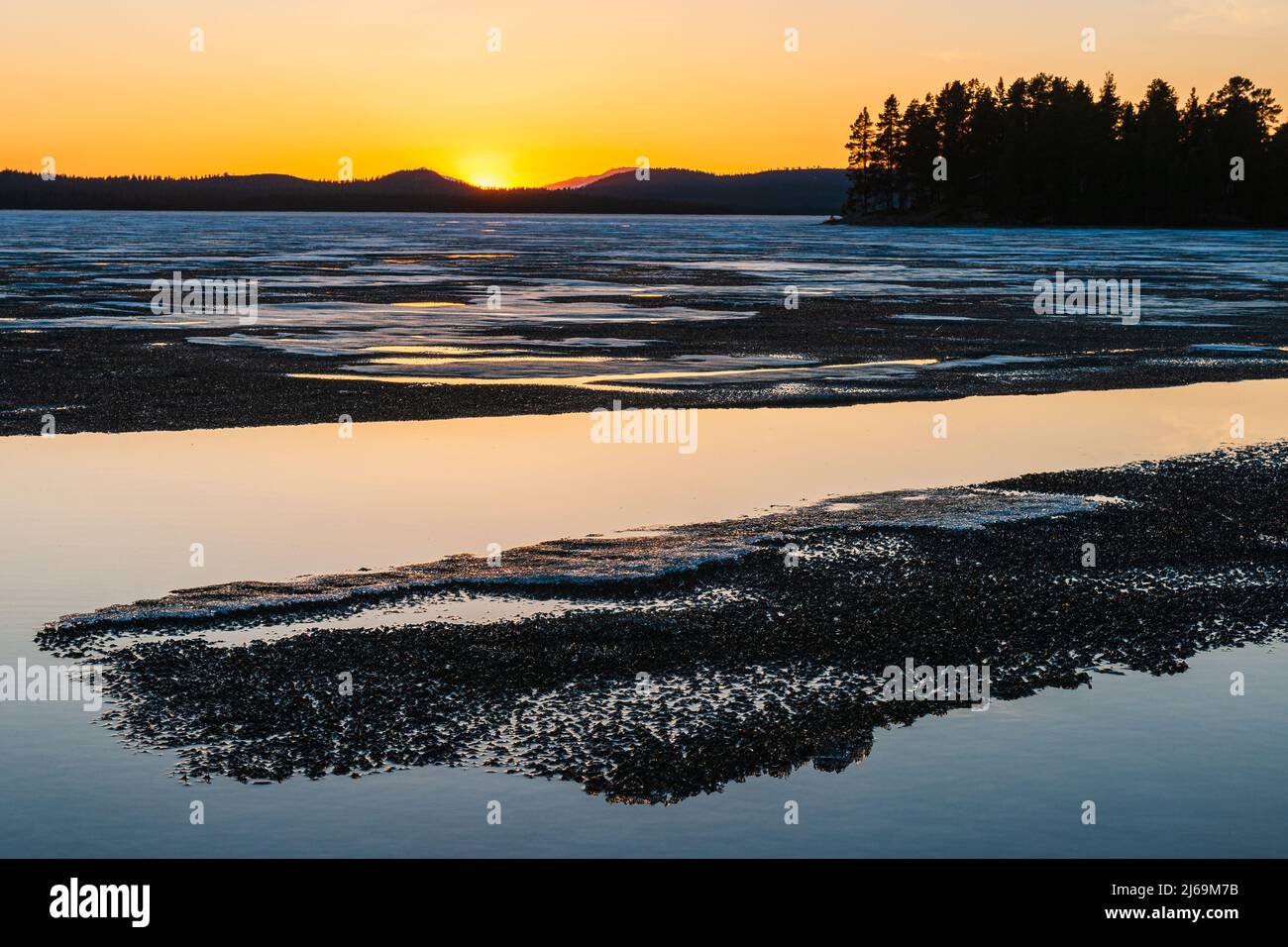 Sunset by frozen lake, Norway Stock Photo