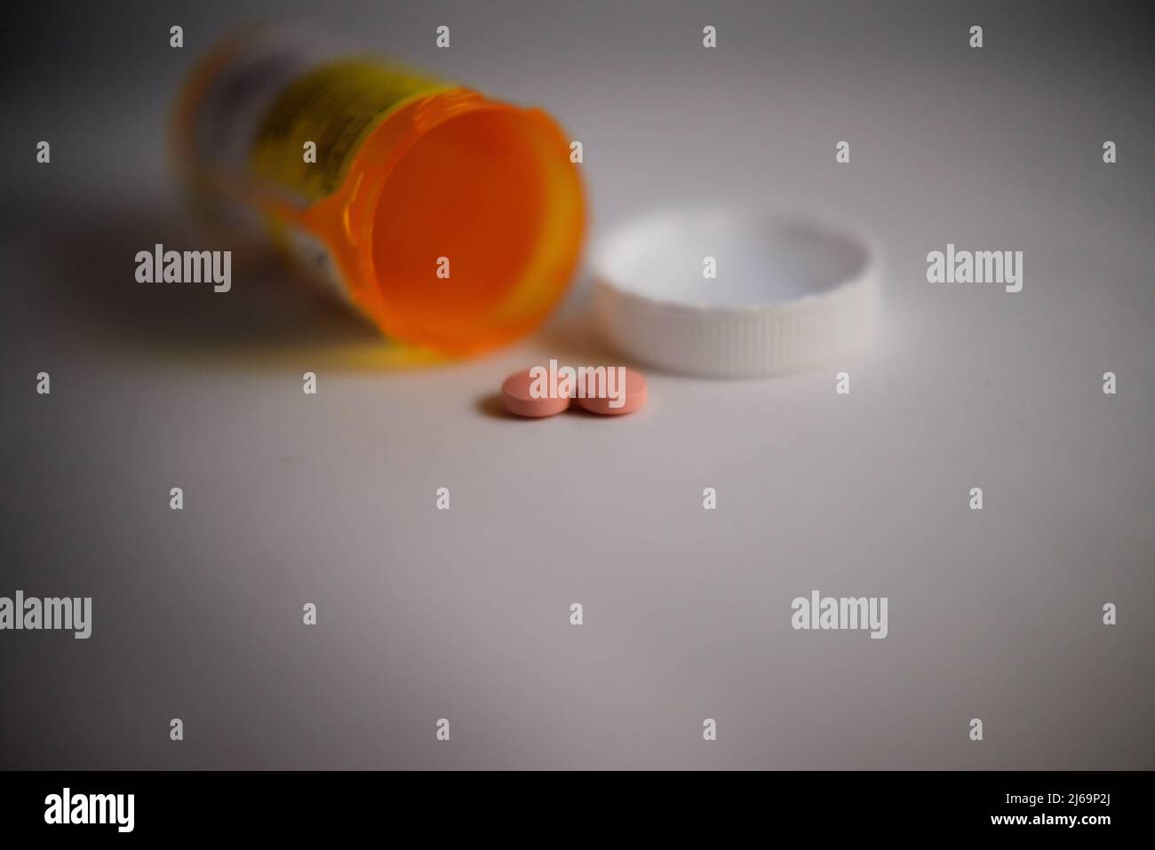 Soft-focus fallen medicine bottle and pills. Stock Photo