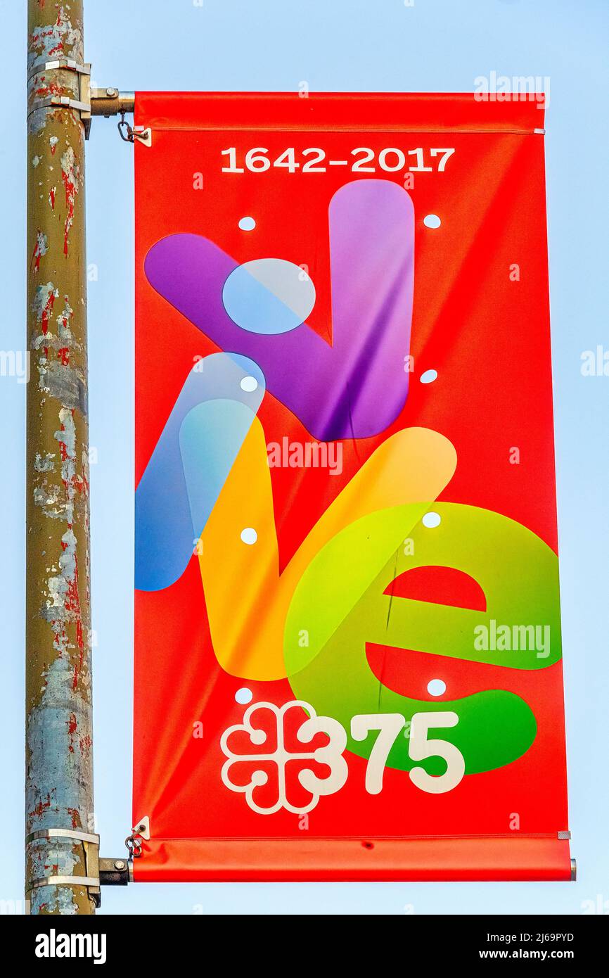 An advertisement banner seen in Old Montreal. The item is marking the 375 anniversary of the city. Stock Photo