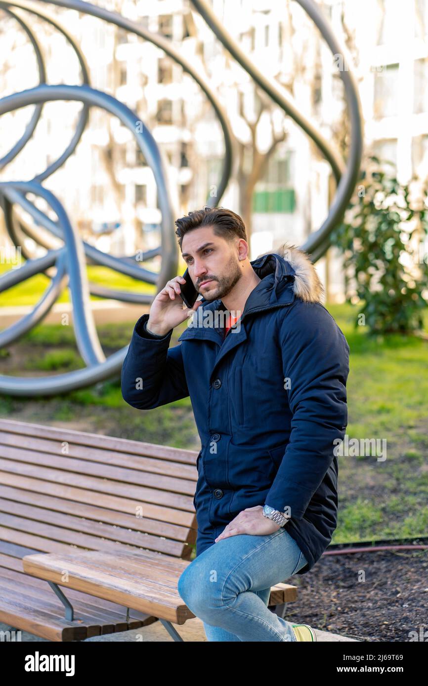 elegant young man talking on his smartphone Stock Photo