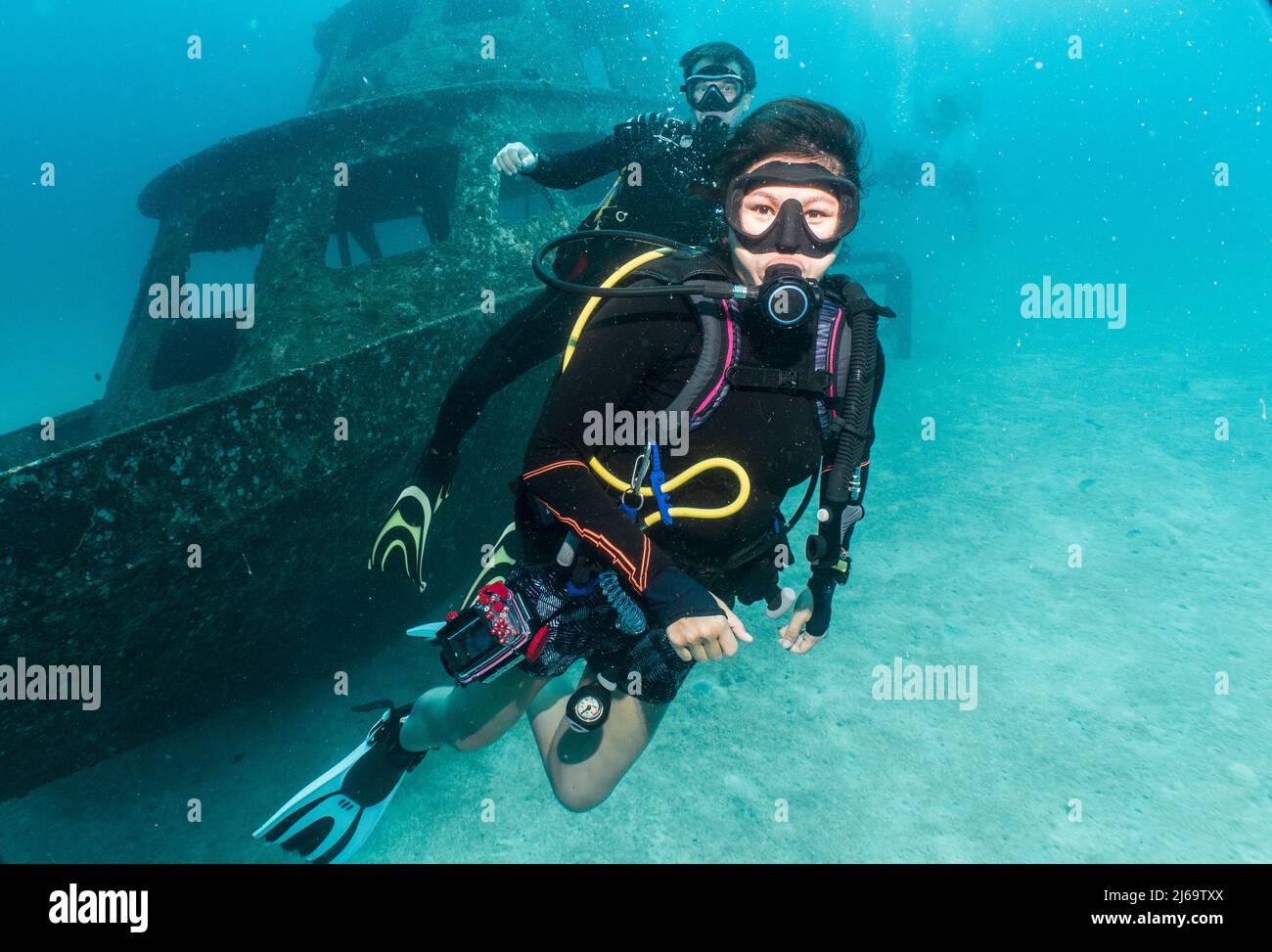 divers exploring a wreck on a dive around Phuket Stock Photo