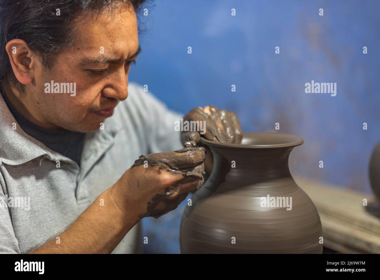 Latin craftsman creating a vase of clay for the talavera process Stock Photo