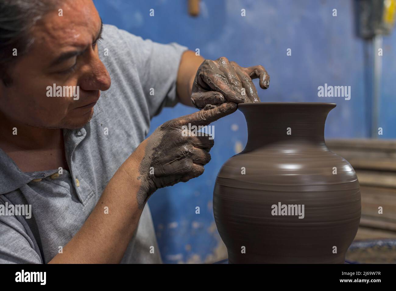 Mexican artisan finishing a vase of clay for the talavera process Stock Photo