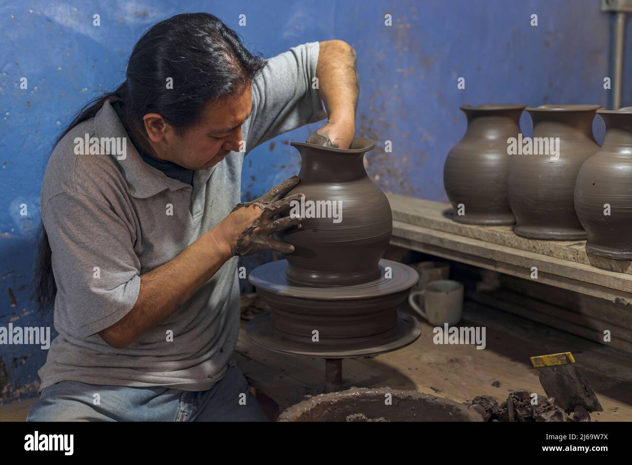 Mexican artisan creating a vase of clay for the talavera process Stock Photo