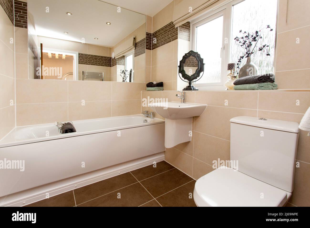 Modern tiled bathroom in neutral colours colors. Stock Photo