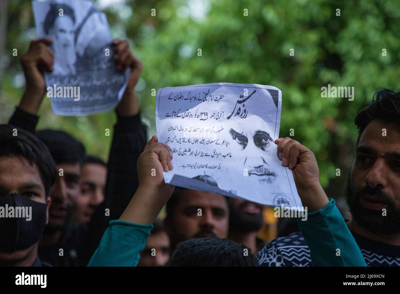 A Kashmiri Muslim boy holds a placard while shouting Pro Palestine and ...