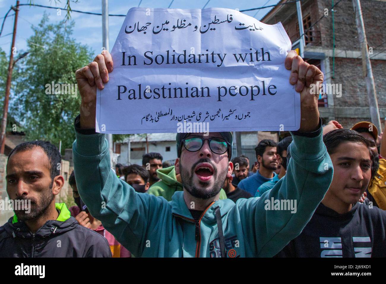 A Kashmiri Muslim boy holds a placard during a rally marking Quds ...