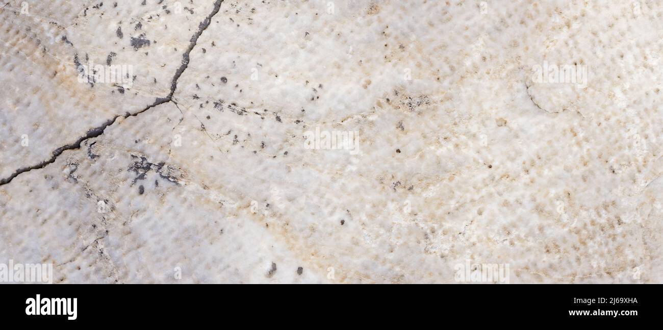 Cracked antique marble texture. Weathercracked stone wall. Marble