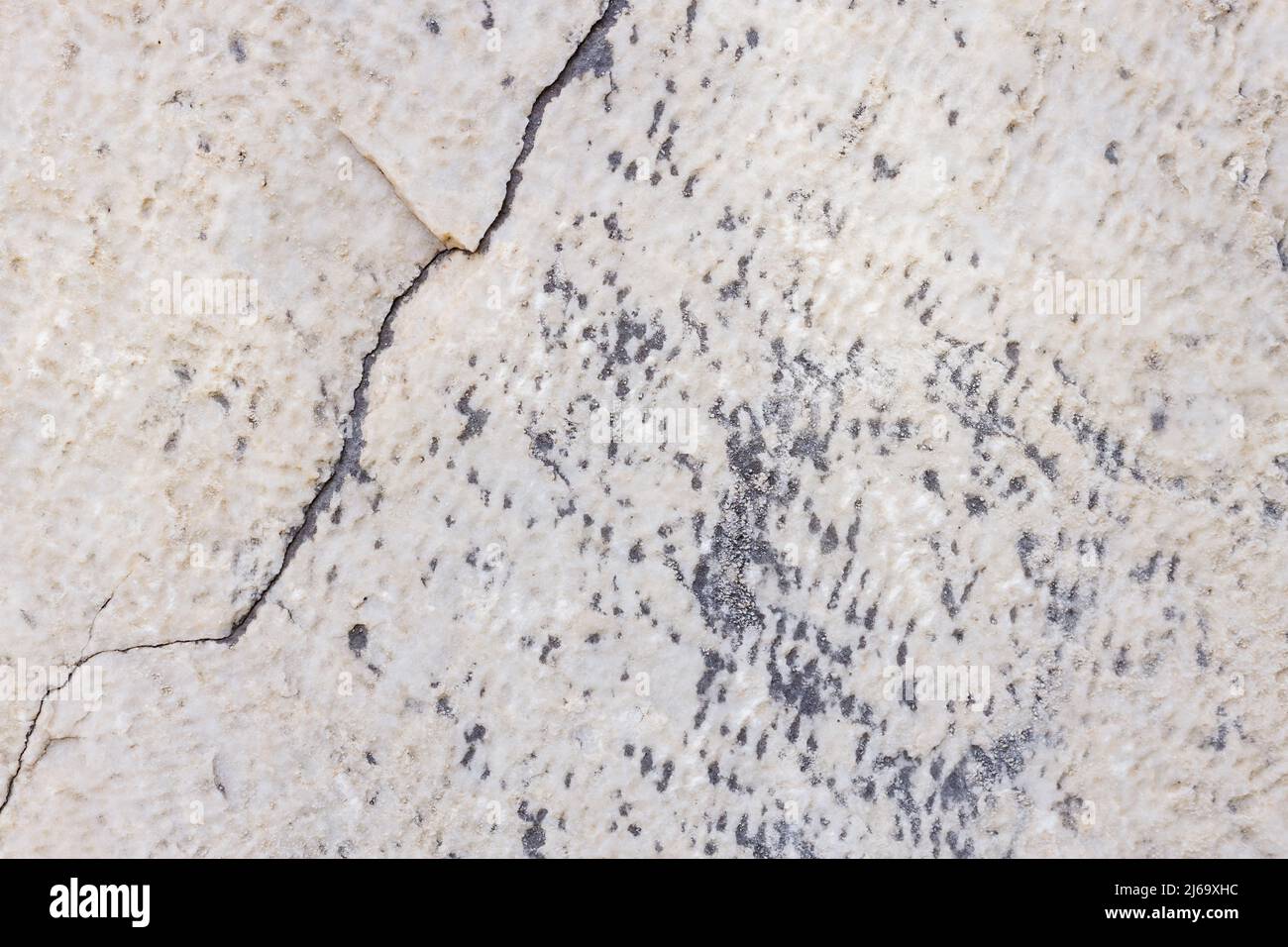 Cracked antique marble texture. Weathercracked stone wall. Marble