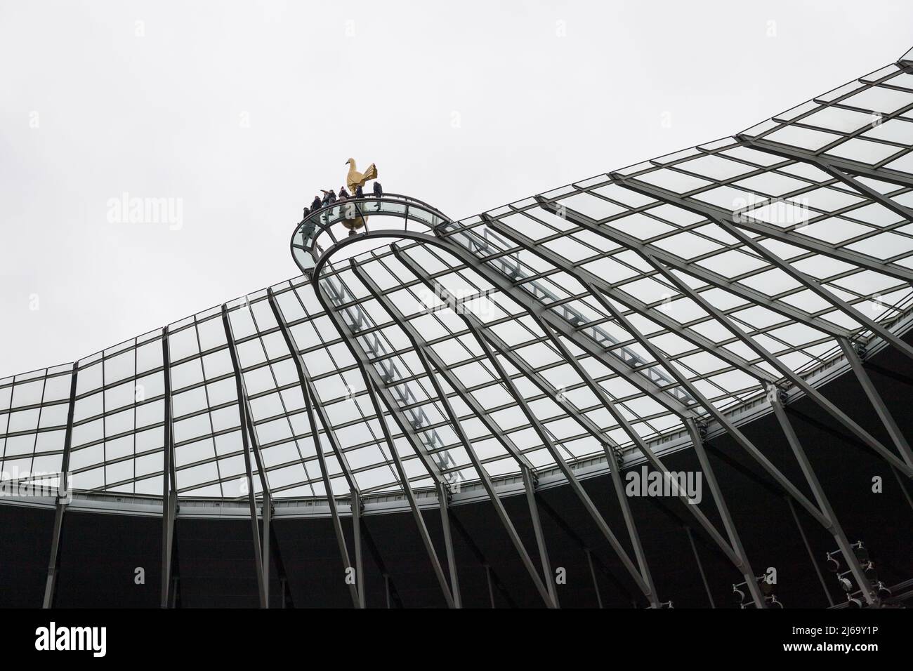 Visitors near the cockerel statue on the roof of the Tottenham Hotspur football stadium Stock Photo