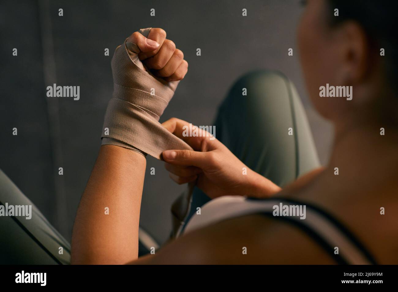 From above horizontal shot of professional female boxing using wristwraps for protecting her hands Stock Photo