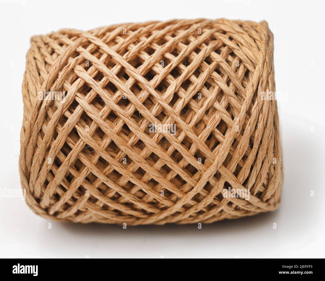 Thread ball made of natural jute fiber over white background Stock
