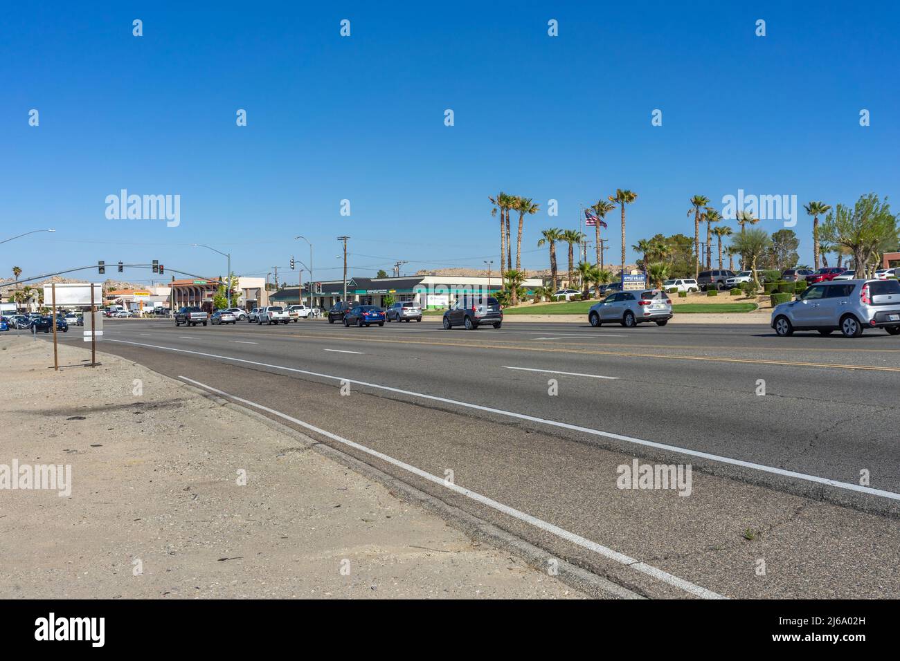 Apple Valley, CA, USA – April 20, 2022: Morning traffic on Happy Trails Highway, CA State Route 18, in the Town of Apple Valley, California. Stock Photo