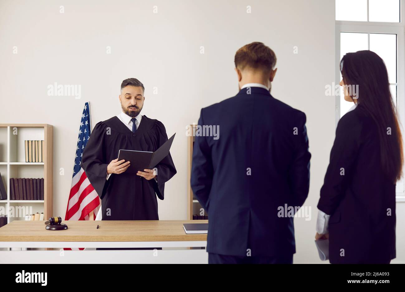 American judge in court of law gives his judgment and enforces punishment on young man Stock Photo