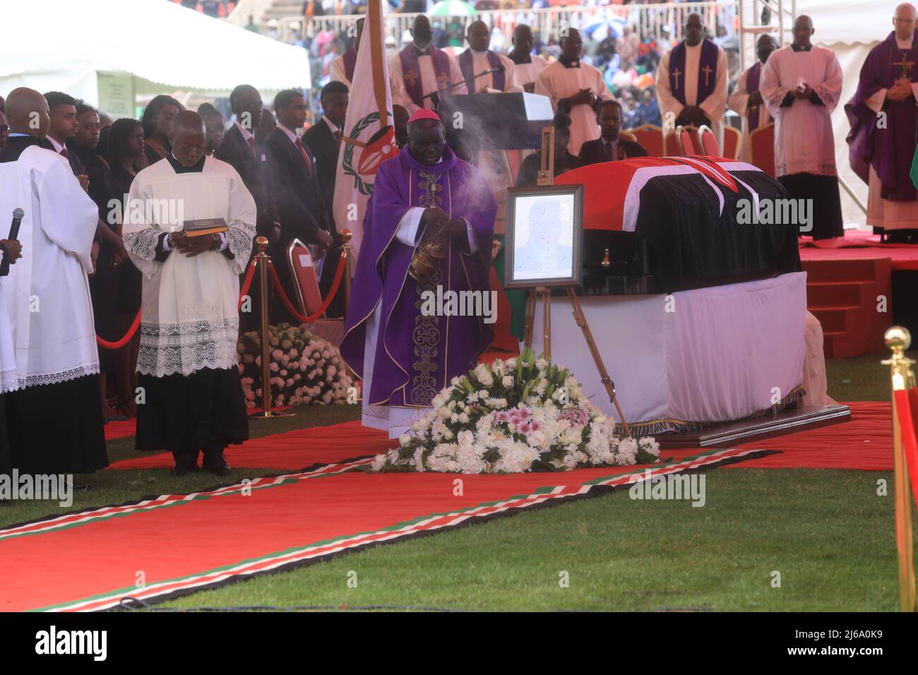 A is pictured blessing the coffin of the late retired president