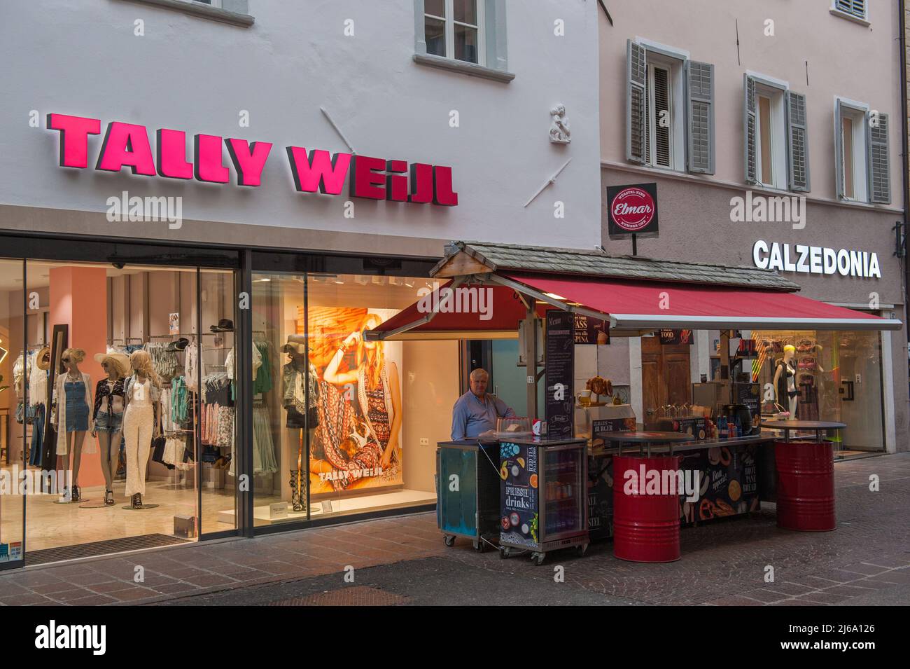 Bolzano, Italy 5/23/2016: Tally Weijl and Calzedonia clothing stores, traditional food vendor © Andrea Sabbadini Stock Photo
