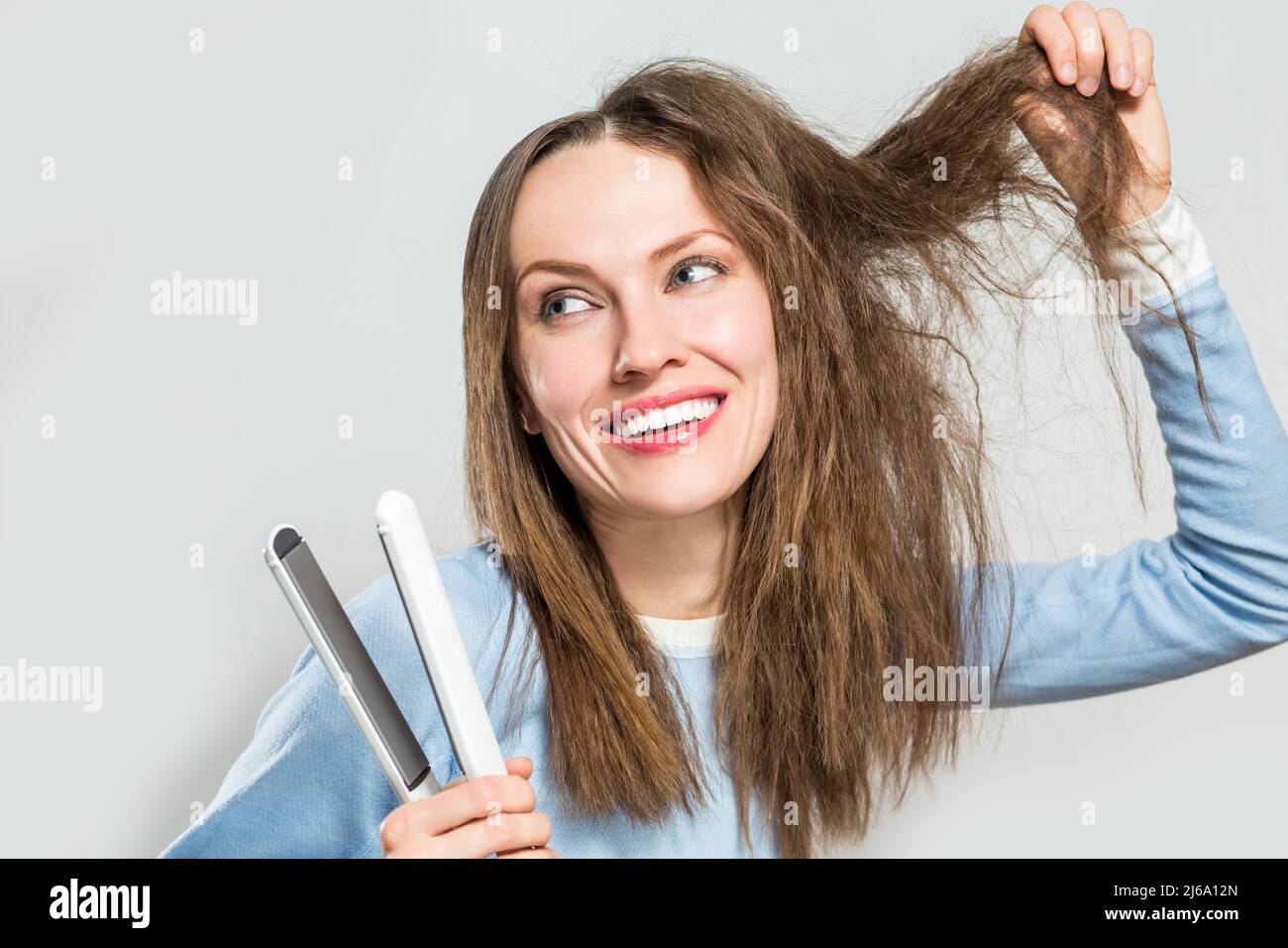 Funny Woman With Messy Hair Holding Straightening Irons Stock Photo - Alamy