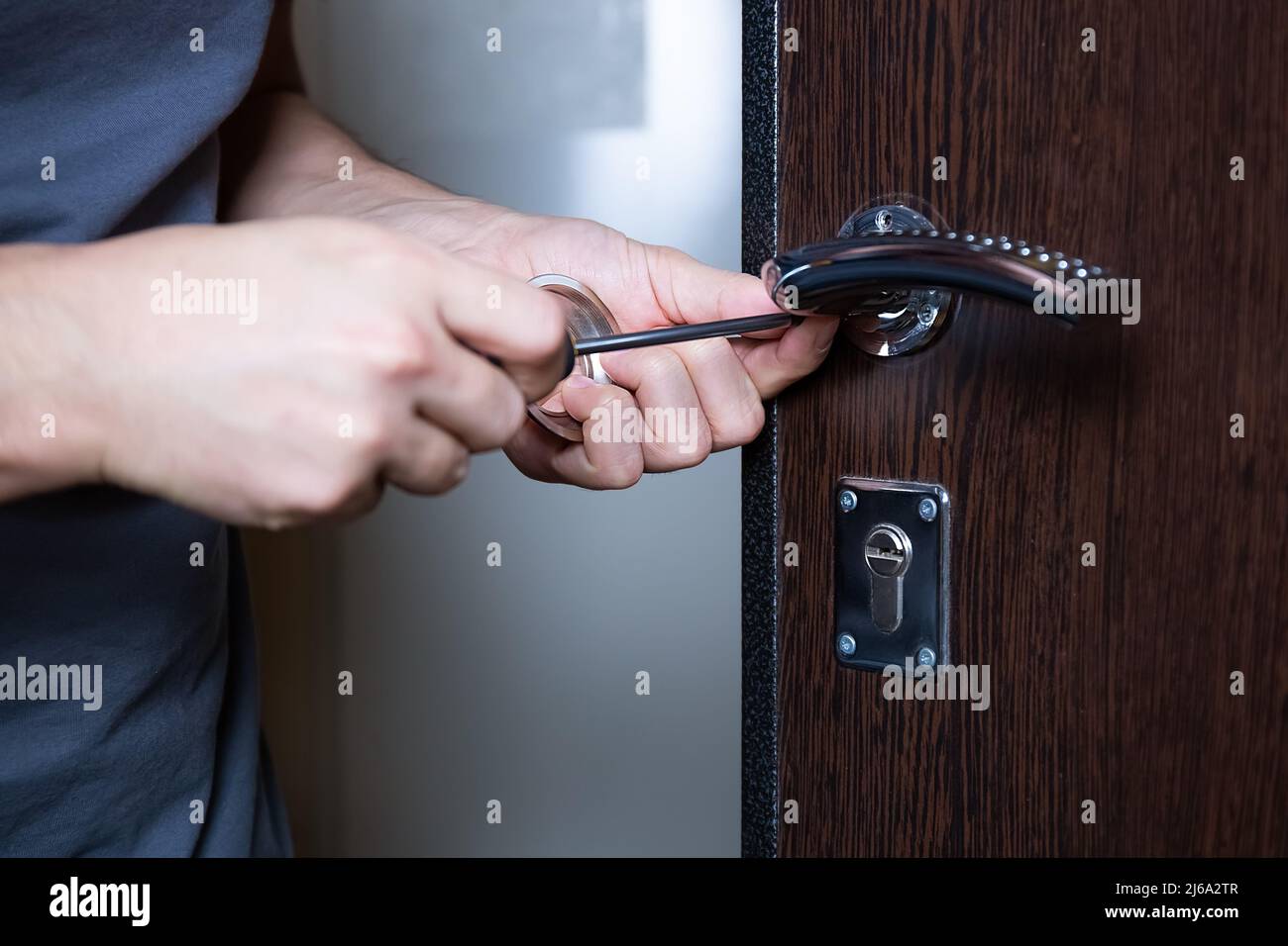 Locksmith replacing door lock to new after losing keys. Robbery