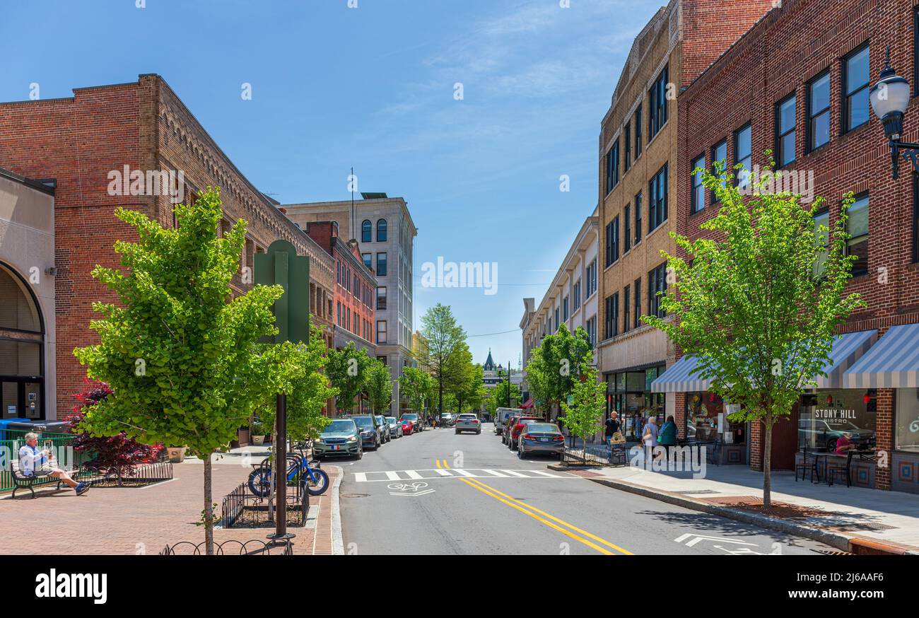 ASHEVILLE, NC, USA-28 APRIL 2022: Iconic wide angle view down Haywood street in downtown. People on sidewalk, detailed historic building facades, chur Stock Photo