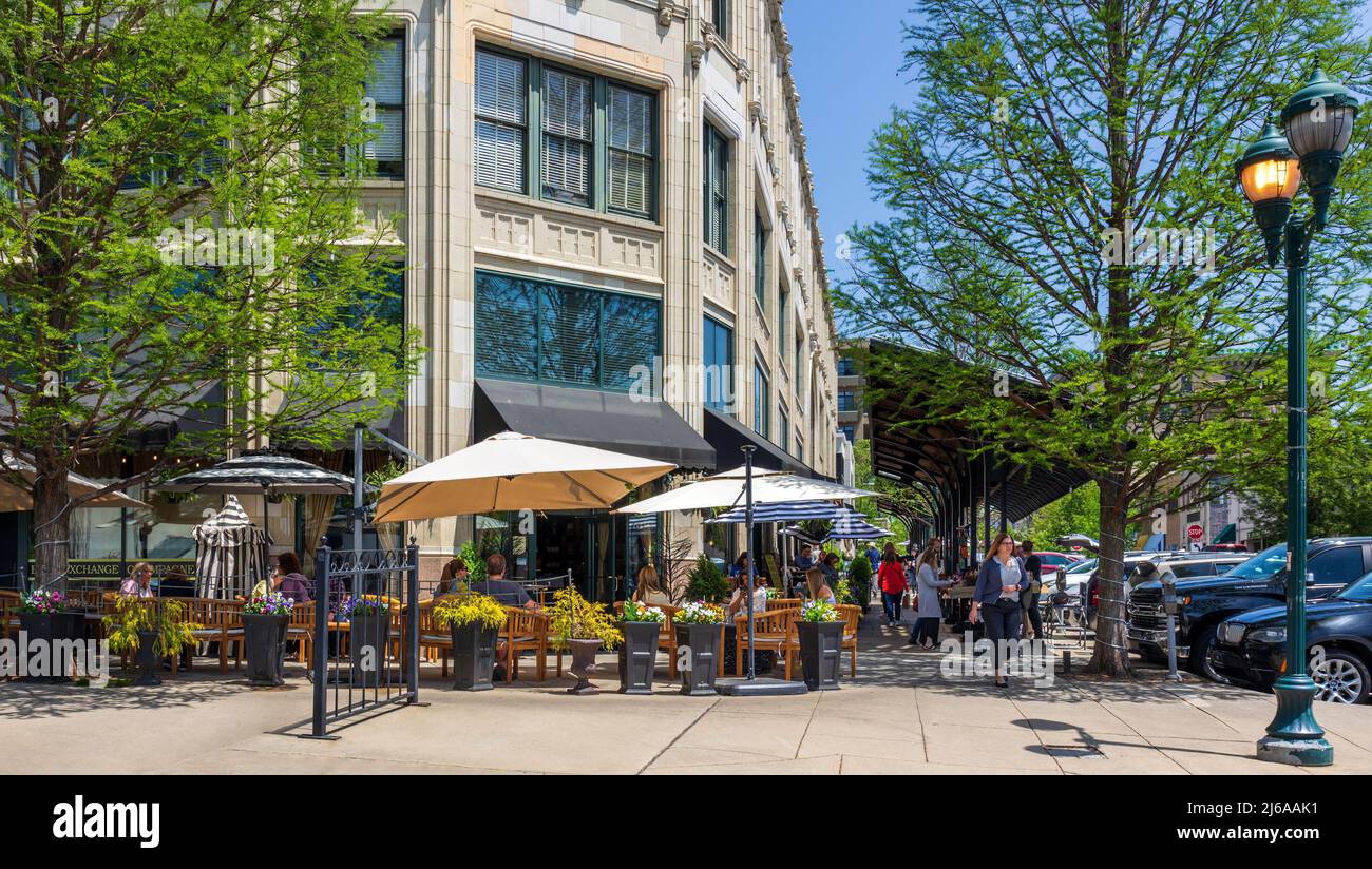 ASHEVILLE, NC, USA-28 APRIL 2022: The Book Exchange Champagne Bar in the Grove Arcade building, showing people at outside seating and craftsmen sellin Stock Photo