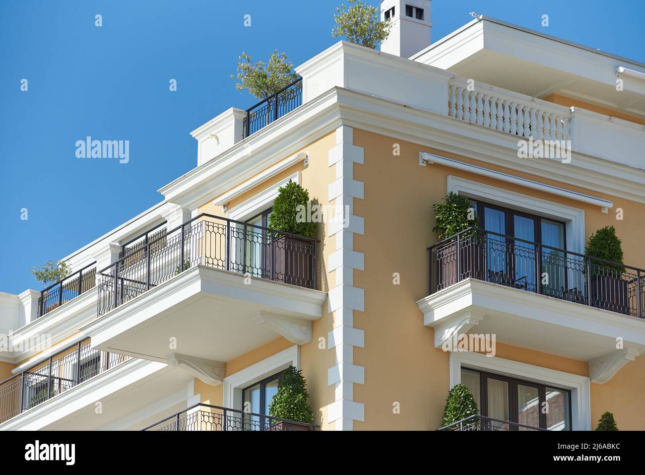 Luxury apartment building with balconies and green plants Stock Photo