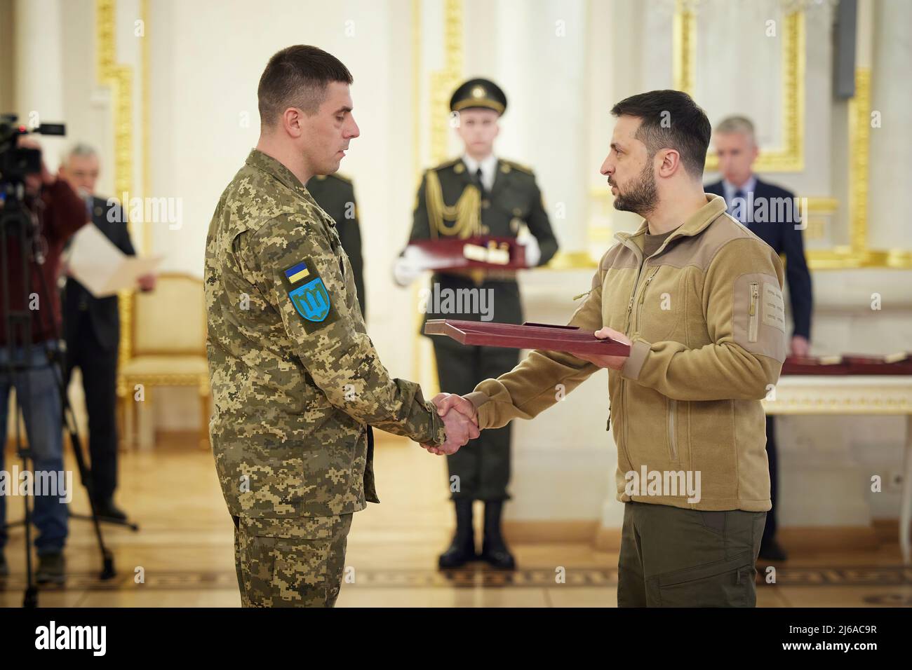 The President of Ukraine Volodymyr Zelenskyy presented the Golden Star orders to servicemen of the Armed Forces of Ukraine who were awarded the title of Hero of Ukraine and to family members of the warriors who were posthumously awarded this title.  The solemn ceremony took place in the White Hall of Heroes of Ukraine at the Mariyinsky Palace in Kyiv.  The Head of State stressed that it is a great honor for him to award the heroes who are in our history and always remain in our memory. PHOTO: Ukraine Presidents Office Stock Photo
