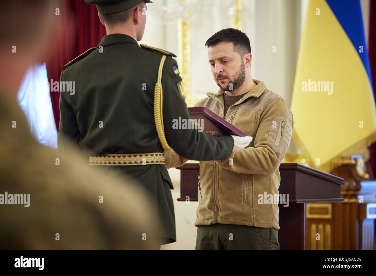 The President of Ukraine Volodymyr Zelenskyy presented the Golden Star orders to servicemen of the Armed Forces of Ukraine who were awarded the title of Hero of Ukraine and to family members of the warriors who were posthumously awarded this title.  The solemn ceremony took place in the White Hall of Heroes of Ukraine at the Mariyinsky Palace in Kyiv.  The Head of State stressed that it is a great honor for him to award the heroes who are in our history and always remain in our memory. PHOTO: Ukraine Presidents Office Stock Photo