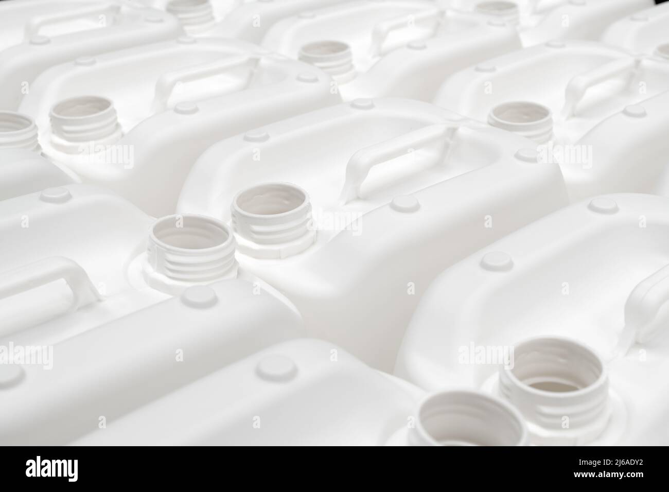 A group of white plastic jerry cans in a factory Stock Photo