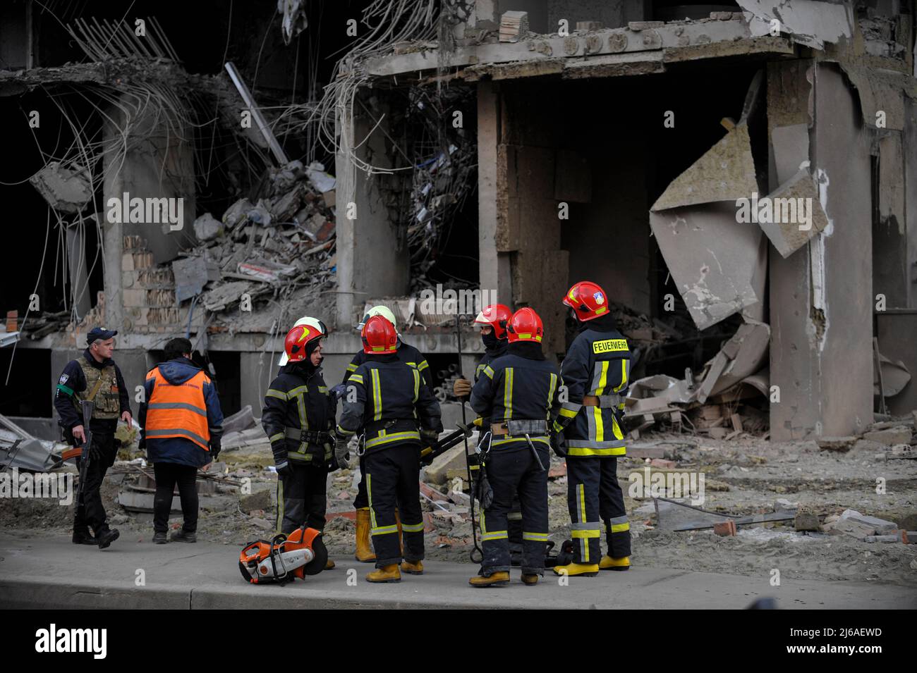Ukrainian rescuers inspect a partially destroyed residential building ...