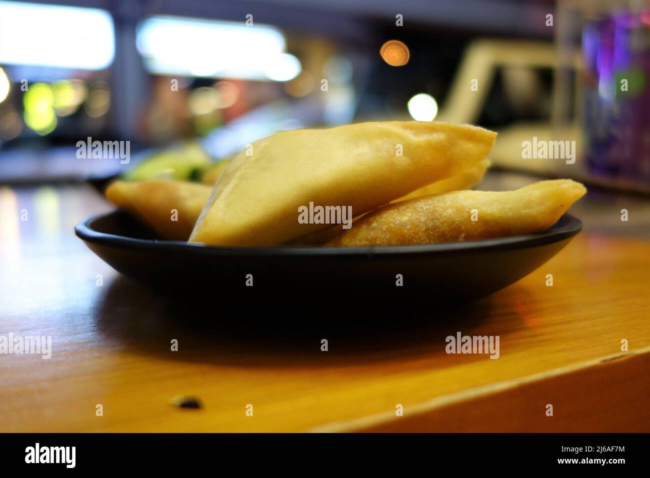 Samosas on a black plate as a close up Stock Photo